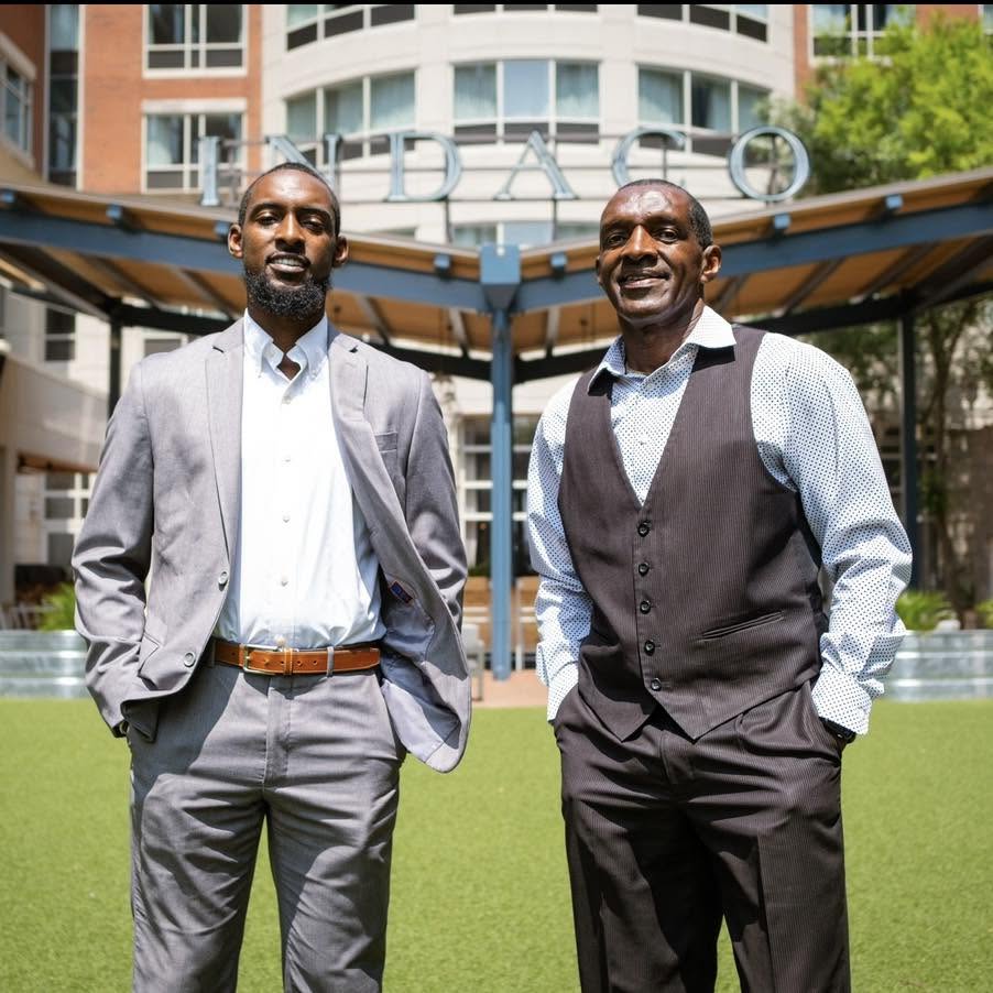 Reggie Griffin Jr. and Reggie Griffin Sr. standing together outdoors