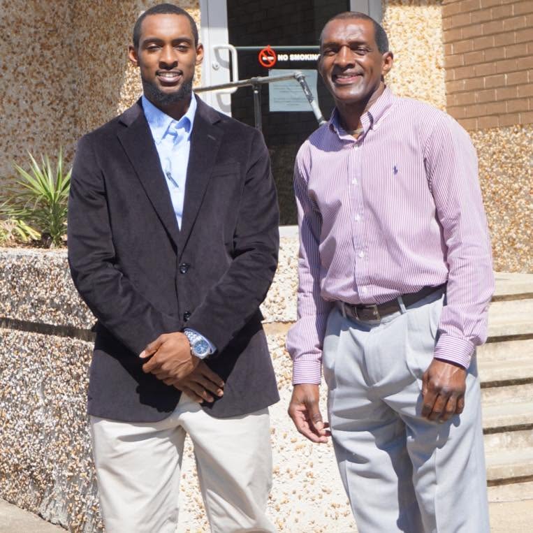 Reggie Griffin Jr. and Reggie Griffin Sr. outside their office